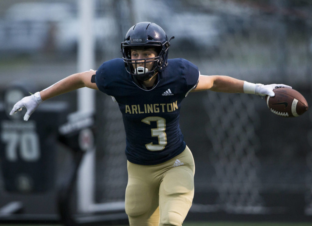 Arlington’s Gage Price celebrates after scoring a touchdown during the game against Oak Harbor on Friday, Sept. 10, 2021 in Arlington, Wa. (Olivia Vanni / The Herald)

