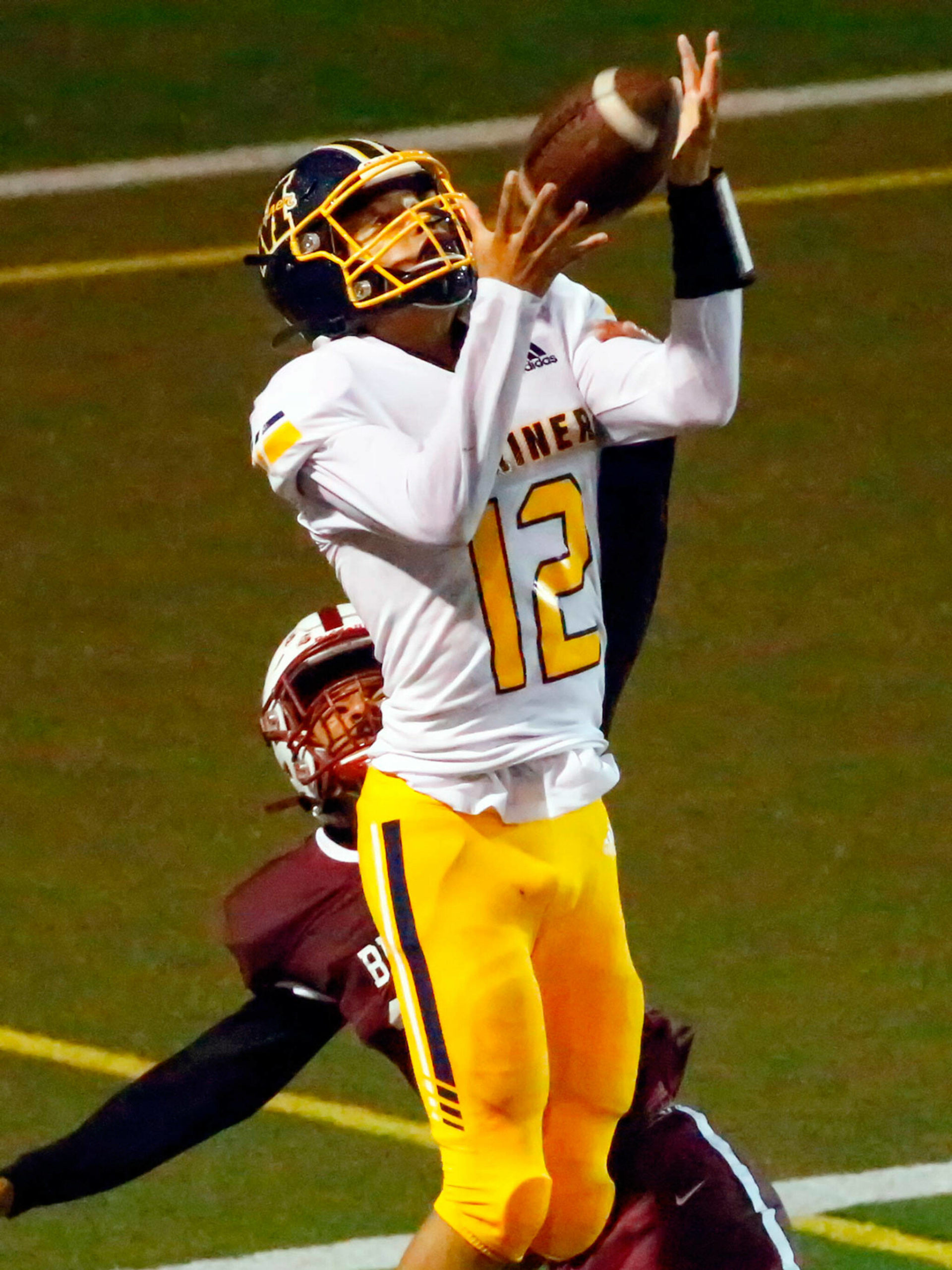 Mariners’ Brandon Rutledge makes the game-winning touchdown reception with Cascade’s Randall Graham defending Friday evening at Everett Memorial Stadium. (Kevin Clark / The Herald)