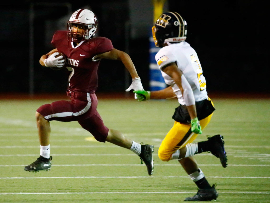 Cascade’s Zach Lopez, left, rushes with Mariners’ Macky James closing Friday evening at Everett Memorial Stadium on September 10, 2021. (Kevin Clark / The Herald)
