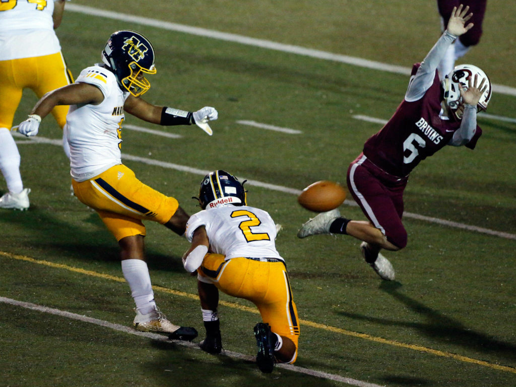 Cascade’s Jordan Mullerleile blocks a extra point attempt by Mariners’ Yisrael Calderon Friday evening at Everett Memorial Stadium on September 10, 2021. (Kevin Clark / The Herald)
