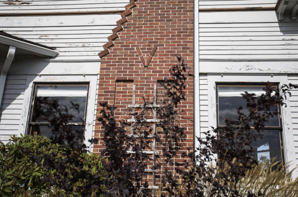 A letter V, representing the name of the original owner, on the chimney of the Van Valey House on Wednesday in Everett. (Olivia Vanni / The Herald)
