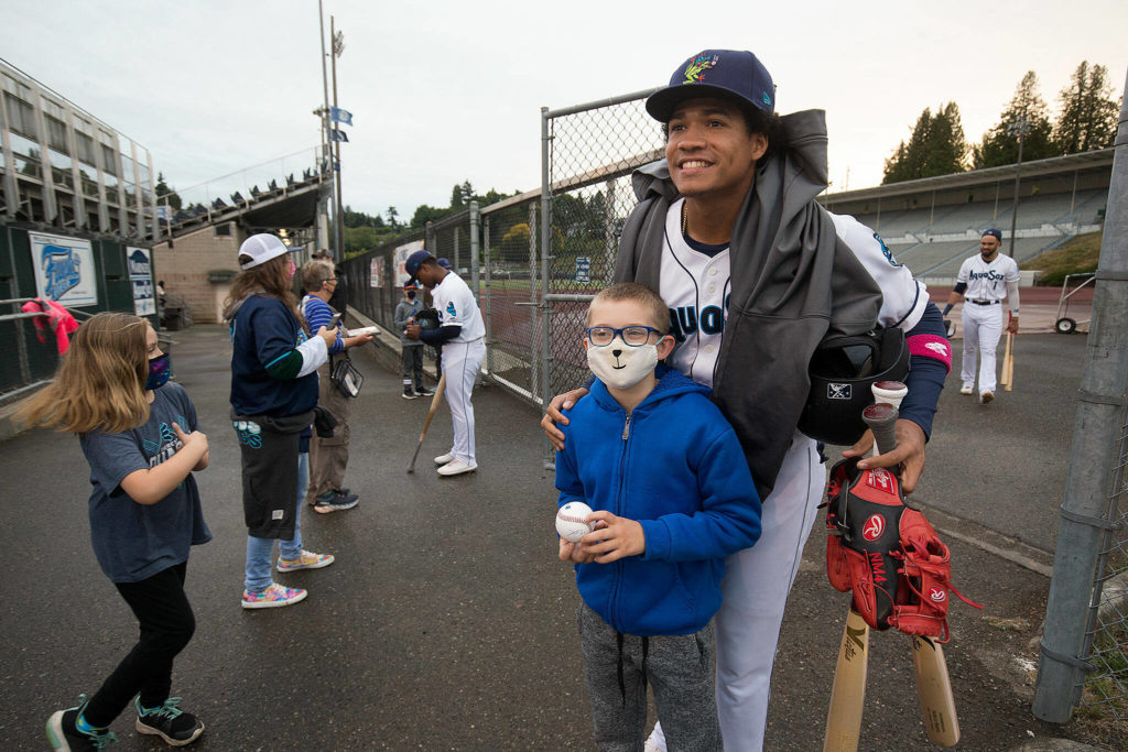 Marte poses for a photo with fan Rowan Rice before Tuesday’s game at Funko Field. (Andy Bronson / The Herald)
