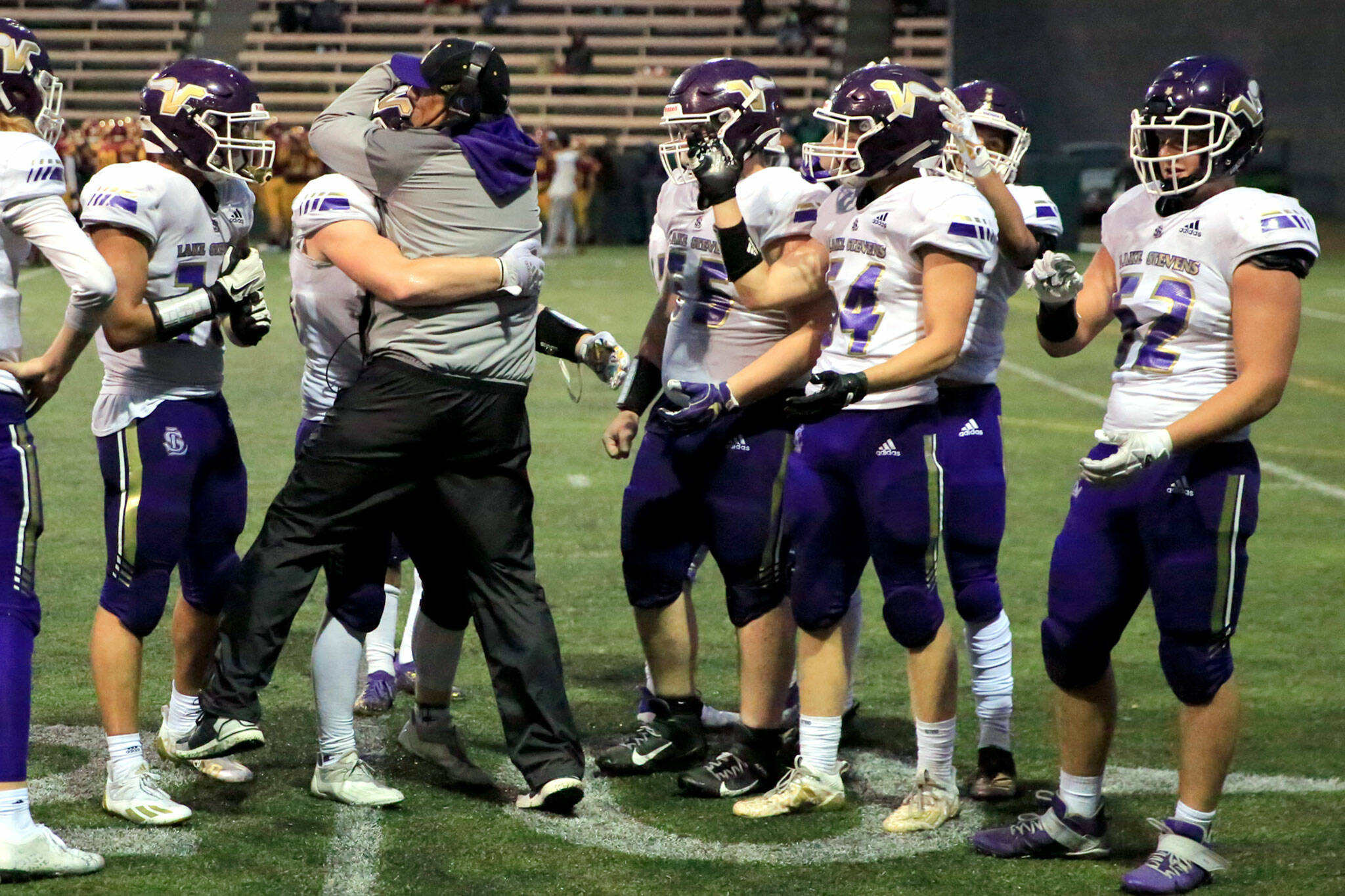 Lake Stevens coach Tom Tri celebrates with his players. (Kevin Clark / The Herald)