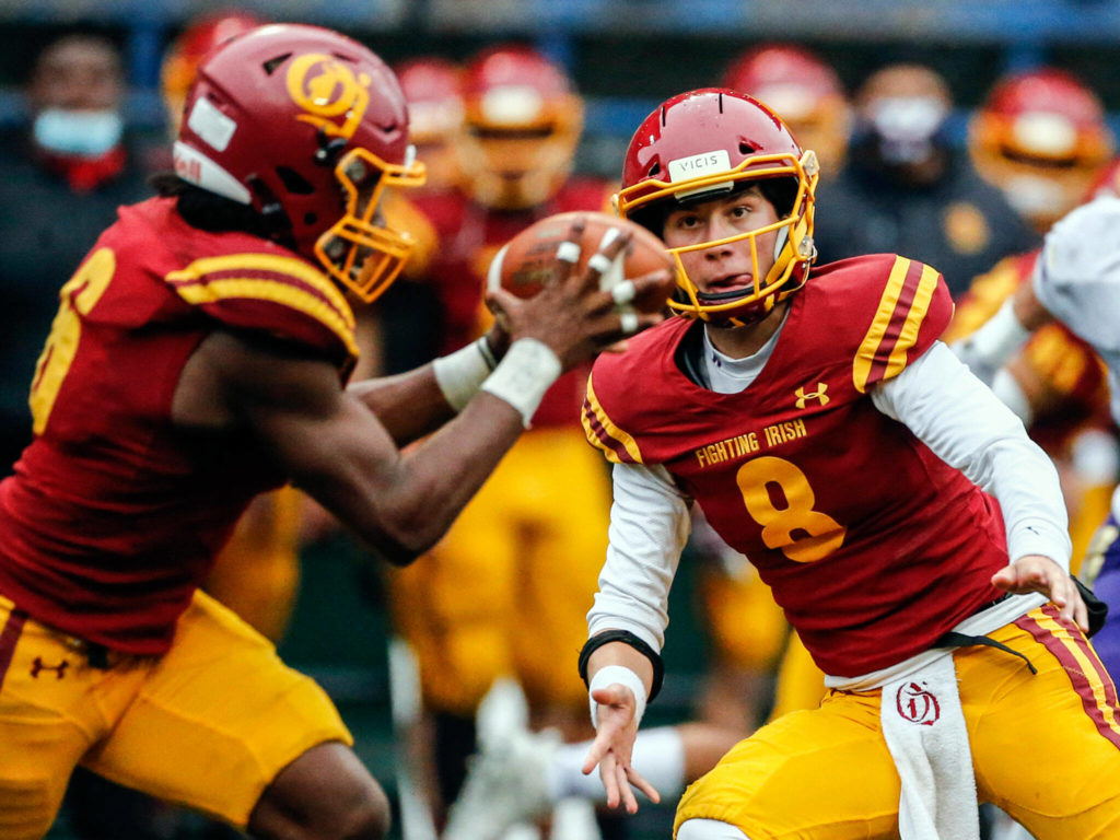 O’Dea’s Jason Brown, Jr. gets a shuffle pass from John Kohler Friday at Memorial Stadium in Seattle on September 17, 2021. The Vikings defeated the Irish, 20-3. (Kevin Clark / The Herald)
