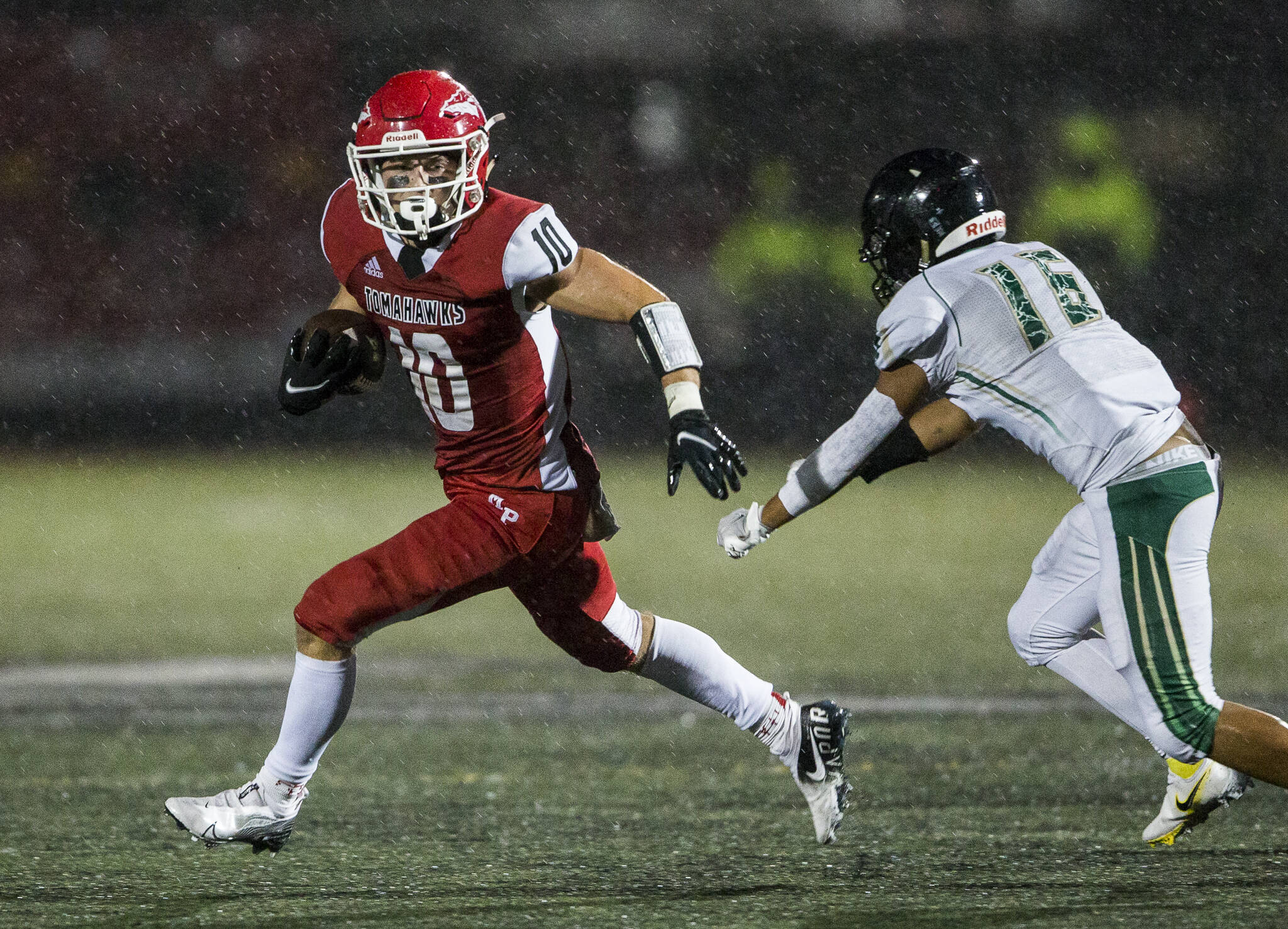 Marysville Pilchuck’s Jordan Velasquez escapes a tackle to run the ball in for a touchdown during the annual Berry Bowl against Marysville Getchell on Friday in Marysville, Wa. (Olivia Vanni / The Herald)