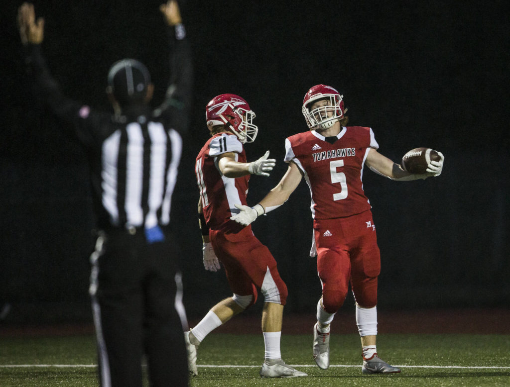 Marysville Pilchuck’s Dylan Carson celebrates his touchdown with Lucian Curtis during the annual Berry Bowl against Marysville Getchell on Friday, Sept. 17, 2021 in Marysville, Wa. (Olivia Vanni / The Herald)
