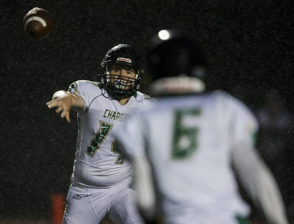 Marysville Getchell’s Logan Maddock passes the ball to Carter Schmidt during the annual Berry Bowl on Friday, Sept. 17, 2021 in Marysville, Wa. (Olivia Vanni / The Herald)
