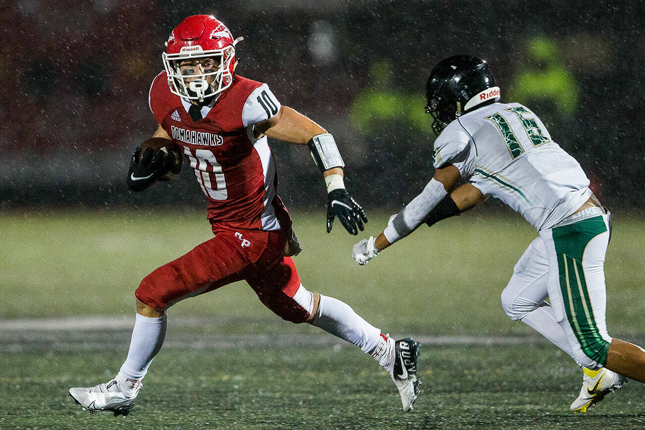 Marysville-Pilchuck's Jordan Velasquez escapes a tackle to run the ball in for a touchdown during the annual Berry Bowl against Marysville Getchell on Friday, Sept. 17, 2021 in Marysville, Wa. (Olivia Vanni / The Herald)