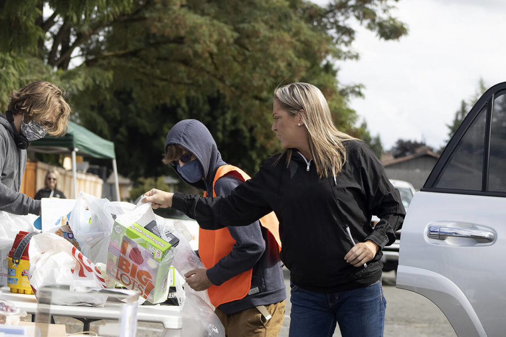 Members of the community dropped off dozens of bags of new toys in honor of Erik Denton’s three slain children during a toy drive. (Isabella Breda / The Herald)
