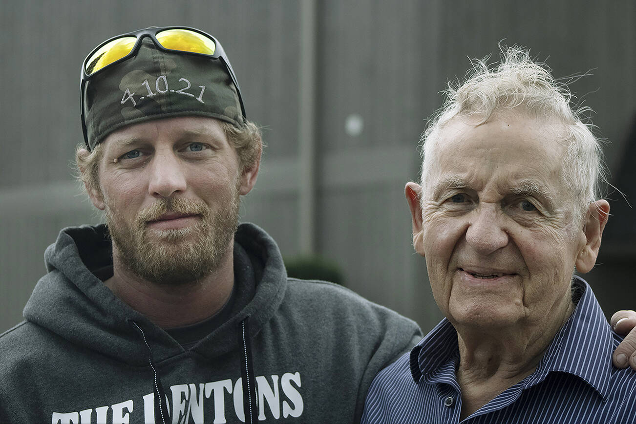 Erik Denton (left) has been staying with his grandpa Terry Hubbard (right) in Marysville while the family holds several events honoring Denton's three slain children. (Isabella Breda / The Herald)