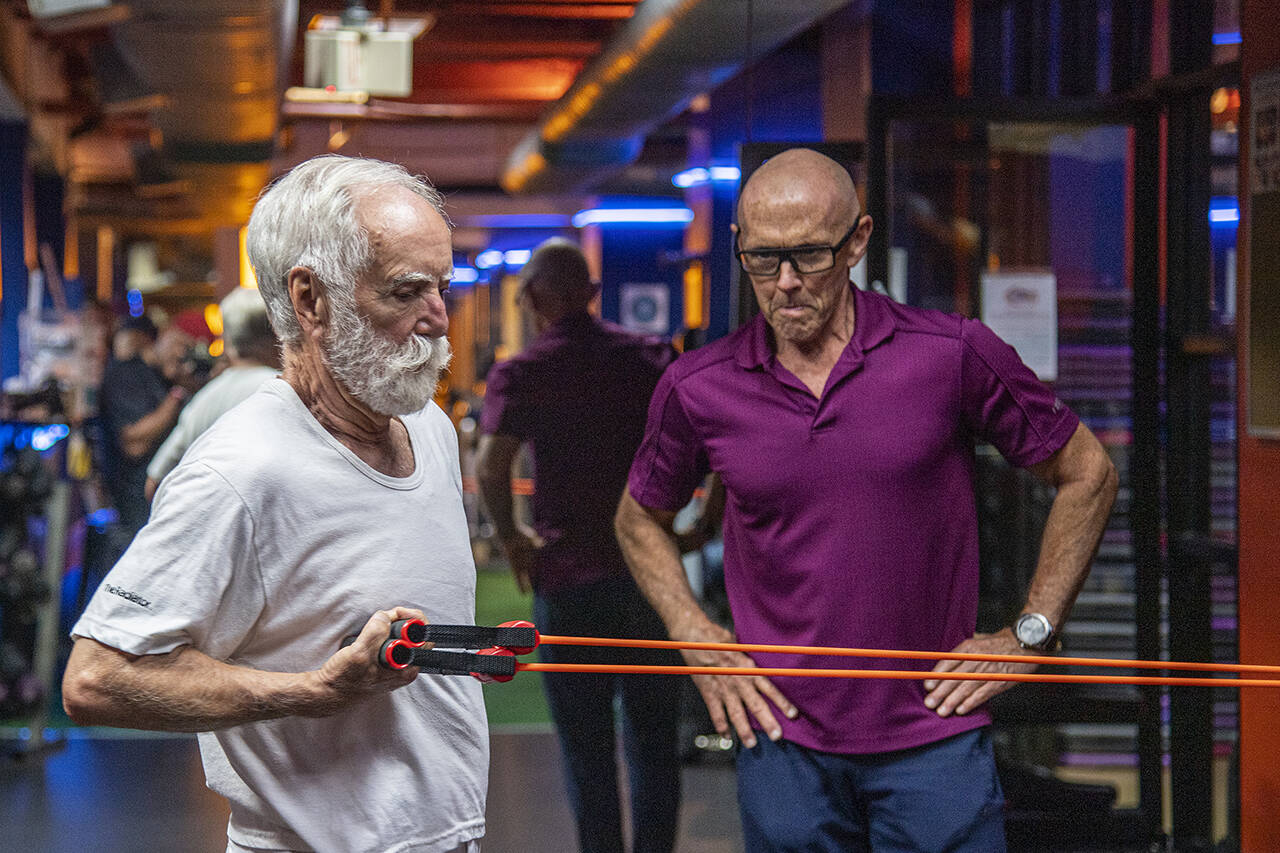 David Pallett, 77, works out with personal trainer Jim Hart on Aug. 30 at Optimal Sport Gym in Philadelphia. (Jose F. Moreno / The Philadelphia Inquirer)