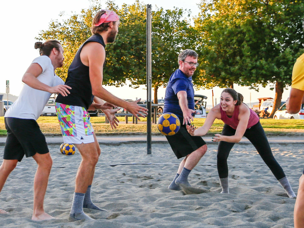 Sarah Aguero, far right, makes a pass with Clancey Aguero defending while playing korfball Sept. 9 at Mukilteo Beach. (Kevin Clark / The Herald)
