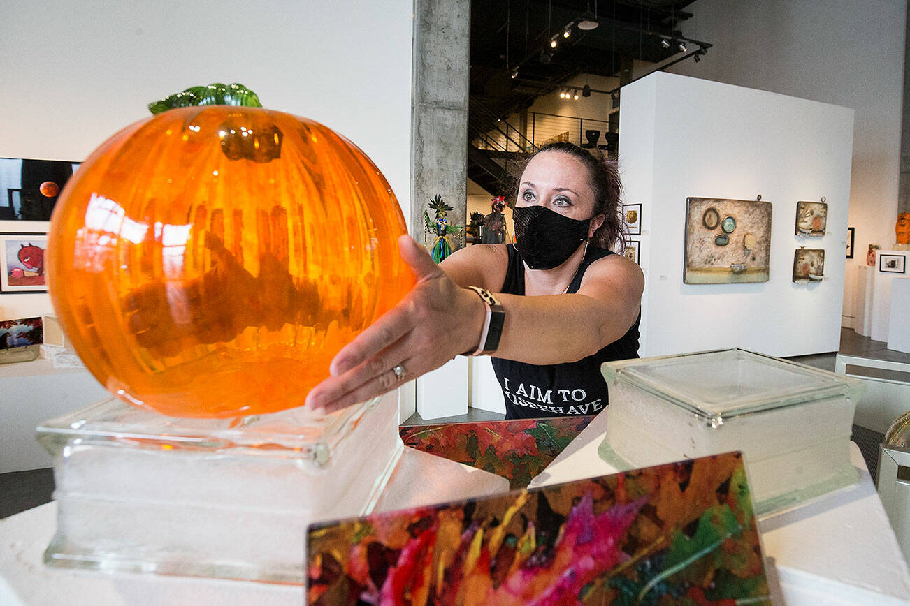 Josey Wise puts out one of the hundreds of glass pumpkins on a display at the Schack Art Center for the upcoming Schack-toberfest on Wednesday, Sept. 22, 2021 in Everett, Washington. The festival runs from Sept, 23 to Nov. 6. (Andy Bronson / The Herald)