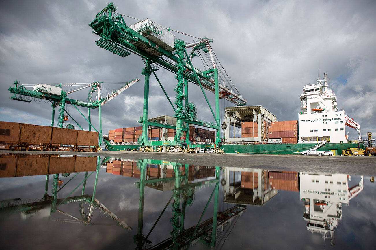 The 214-foot tall cranes work to unload their first cargo shipments at South Terminal at the Port of Everett on Thursday, April 8, 2021 in Everett, Wa. (Olivia Vanni / The Herald)