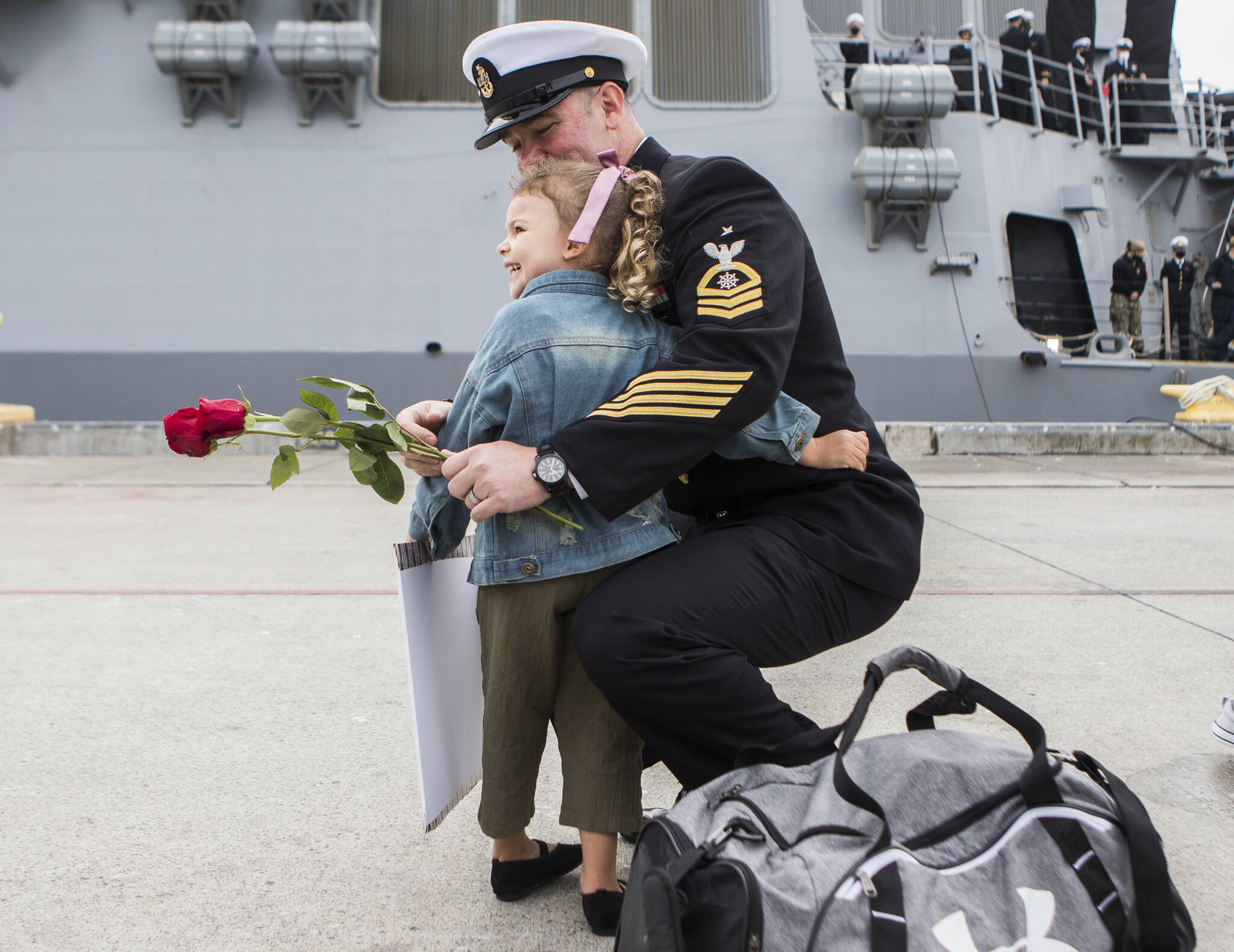 Harlow Gore, 3, hugs her dad, Senior Chief Jerry Gore, after his return from deployment aboard the USS Kidd on Friday in Everett. (Olivia Vanni / The Herald)