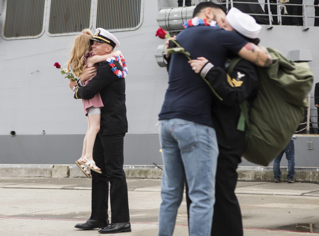 Shane Freeman hugs his daughter, Elizabeth Freeman, 5, after his returns from deployment aboard the USS Kidd on Friday in Everett. (Olivia Vanni / The Herald) 
