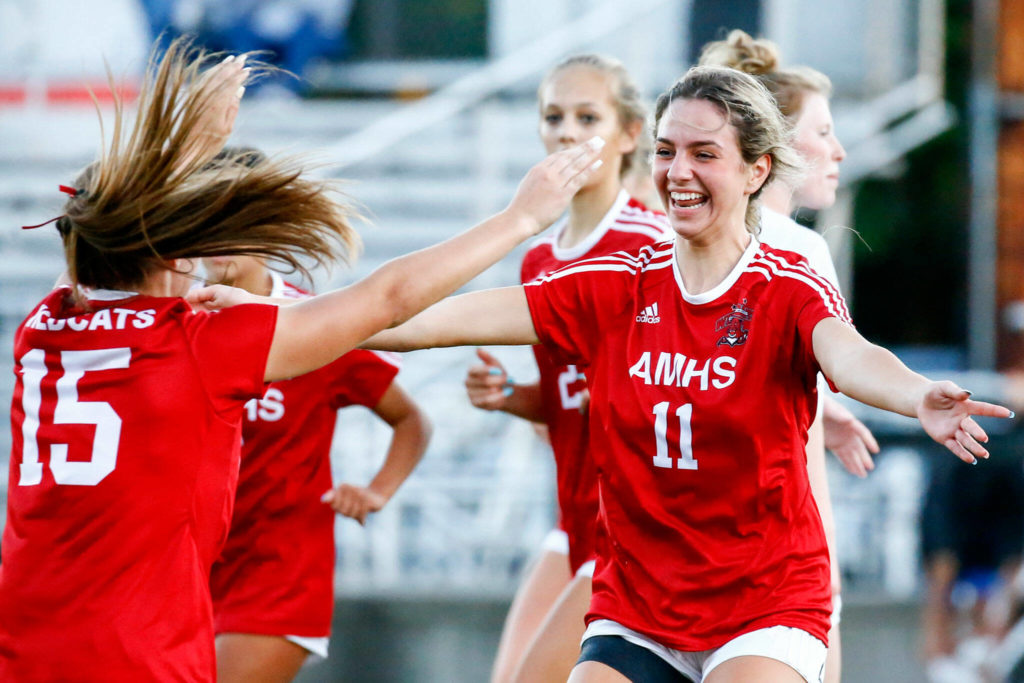 Archbishop Murphy’s Taylor Campbell (right) celebrates her goal off a corner kick from Jordyn Latta (left) during a match against Monroe on Thursday night at Archbishop Murphy High School in Everett. (Kevin Clark / The Herald)
