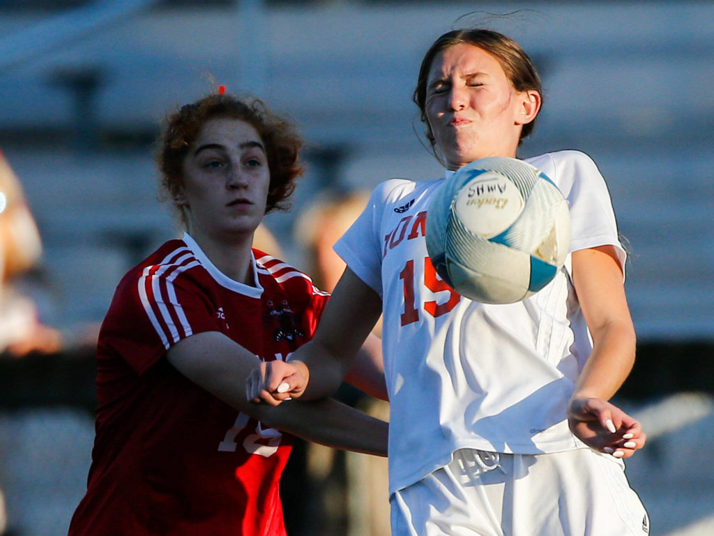 Monroe’s Megan Hurley controls the ball with Archbishop Murphy’s Brie Cote trailing Thursday night at Archbishop Murphy High School in Everett on September 23, 2021. (Kevin Clark / The Herald)
