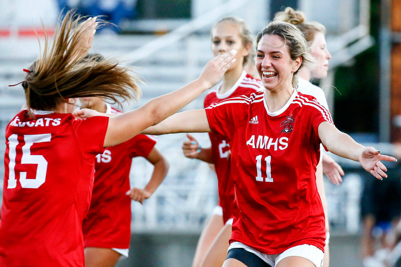 Archbishop Murphy's Taylor Campbell celebrates her header goal off a corner kick from Jordyn Latta, left, Thursday night at Archbishop Murphy High School in Everett on September 23, 2021. (Kevin Clark / The Herald)