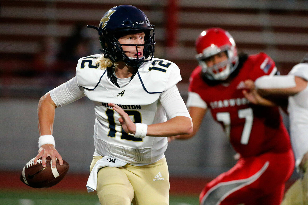 Arlington's Trent Nobach scrambles against Stanwood Friday night at Stanwood High School on September 24, 2021.  (Kevin Clark / The Herald)