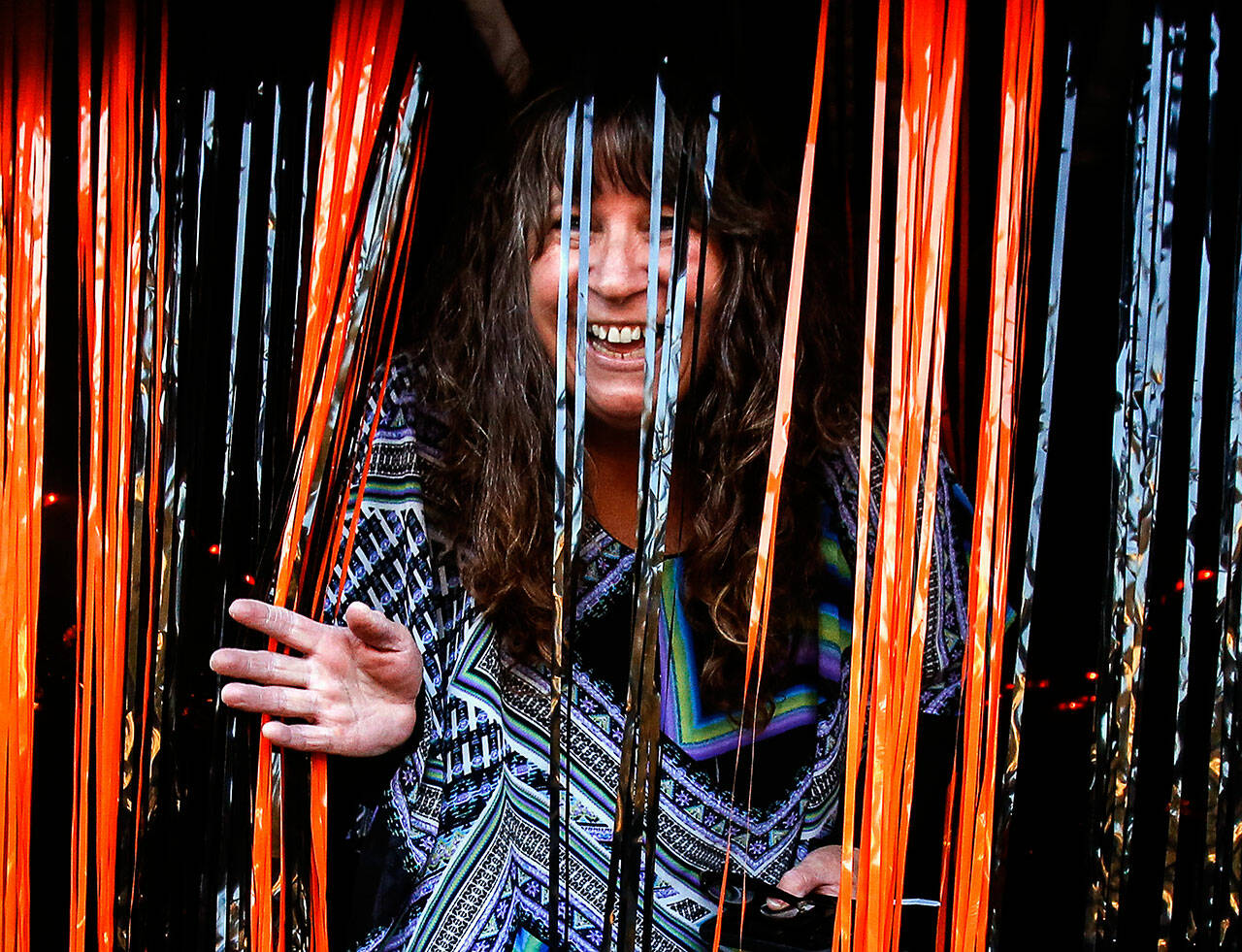Ivy Fulmer emerges from a spooky tunnel she built for the children who visited her on Halloween in Everett’s Riverside nighborhood in 2019. (Dan Bates / Herald file)