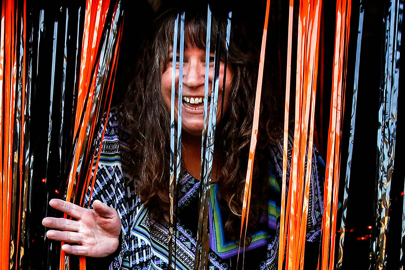 Ivy Fulmer emerges from a spooky tunnel she built for the children who visited her on Halloween in Everett’s Riverside nighborhood in 2019. (Dan Bates / Herald file)