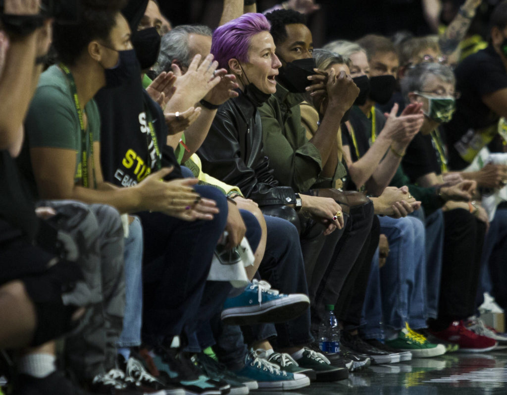 Megan Rapinoe cheers courtside during the second-round, single elimination playoff game against the Phoenix Mercury at Angel of the Winds Arena on Sunday in Everett. (Olivia Vanni / The Herald)
