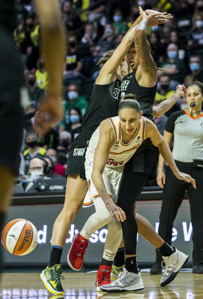 Phoenix Mercury’s Diana Taurasi is double teamed by Seattle’s Stephanie Talbot and Mercedes Russell during the second-round, single elimination playoff game at Angel of the Winds Arena on Sunday in Everett. (Olivia Vanni / The Herald)
