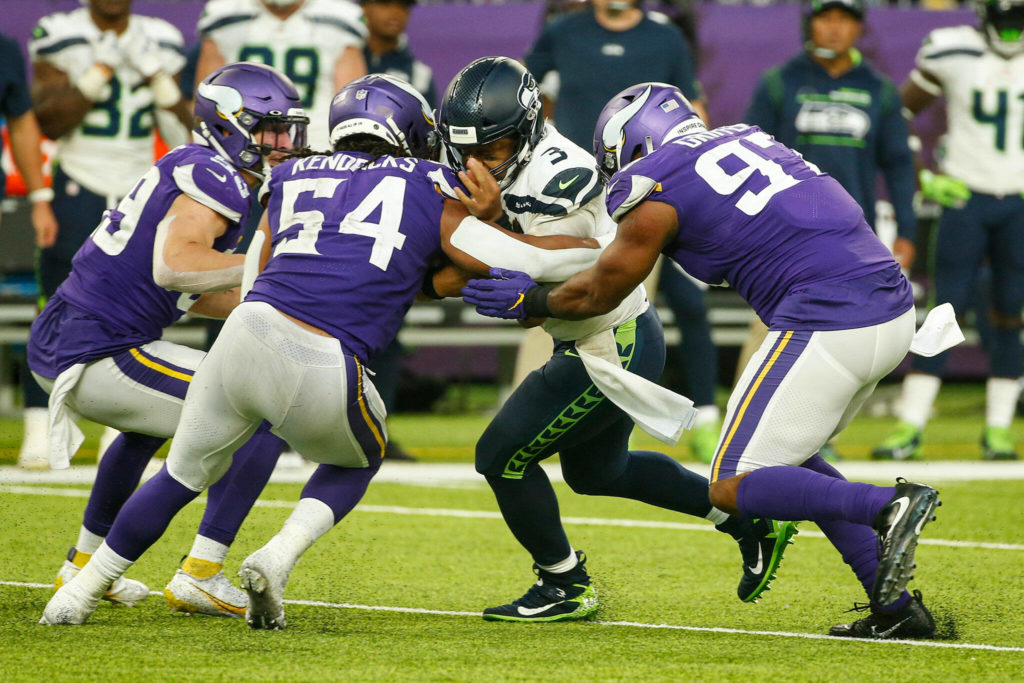 Seattle Seahawks quarterback Russell Wilson (3) is tackled by Minnesota Vikings middle linebacker Eric Kendricks (54) and defensive end Everson Griffen (97) in the second half of Sunday’s game in Minneapolis. (AP Photo/Bruce Kluckhohn)
