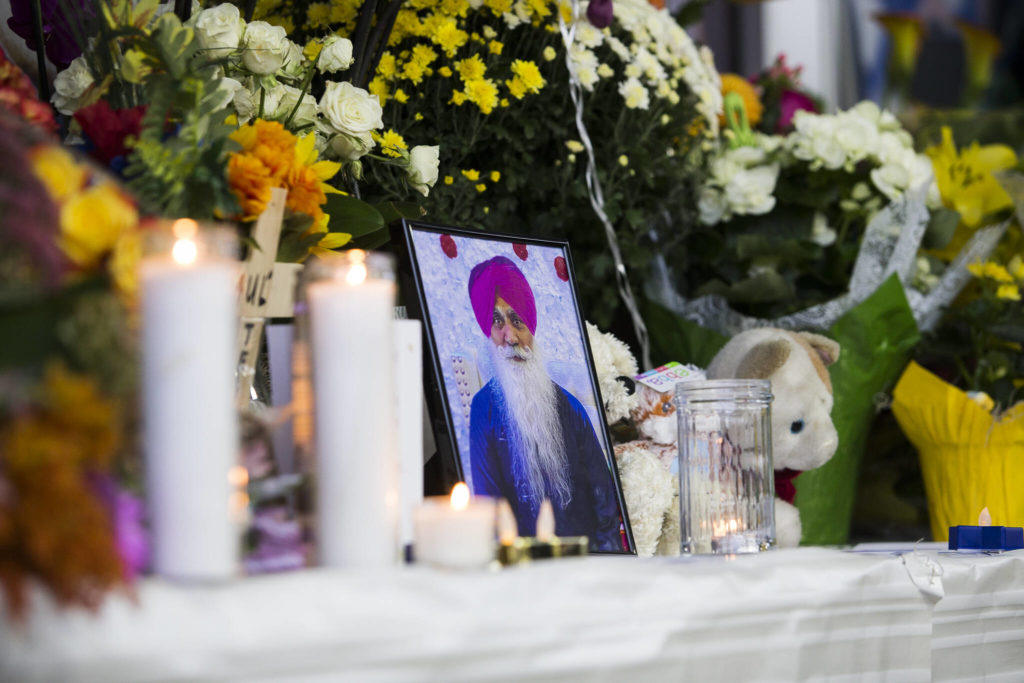 A photograph of TejPal Singh sits on a memorial table at his candlelight vigil Wednesday in Lynnwood. (Olivia Vanni / The Herald)
