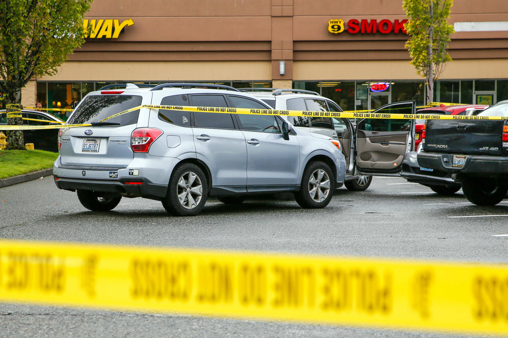 The scene where police from a King County agency shot a man at the end of a car chase Monday afternoon, in a Safeway parking lot south of Snohomish. (Kevin Clark / The Herald)