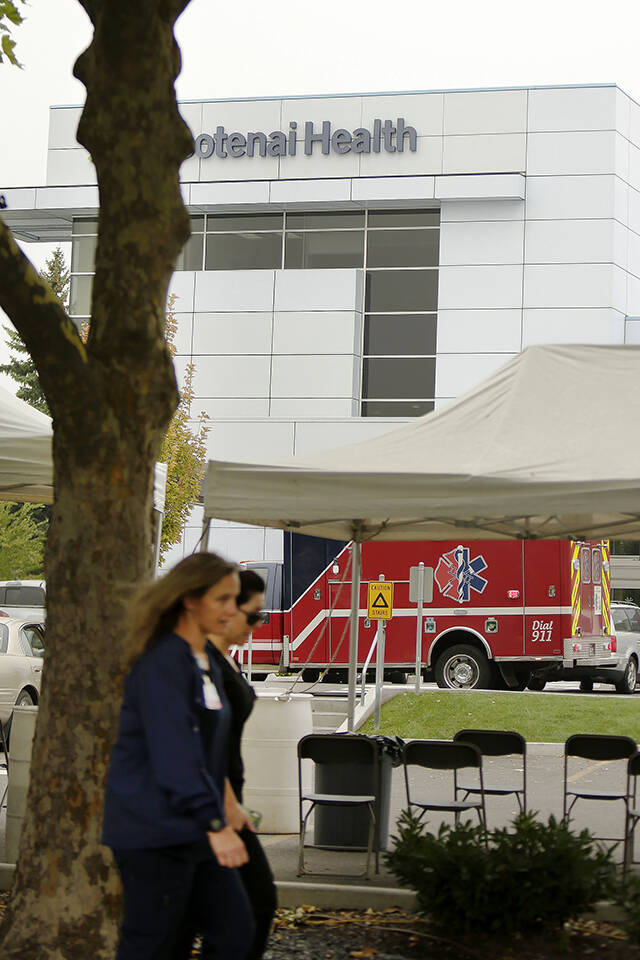Workers walk in front of Kootenai Health on Sept. 10 in Coeur d’Alene, Idaho. (AP Photo/Young Kwak)