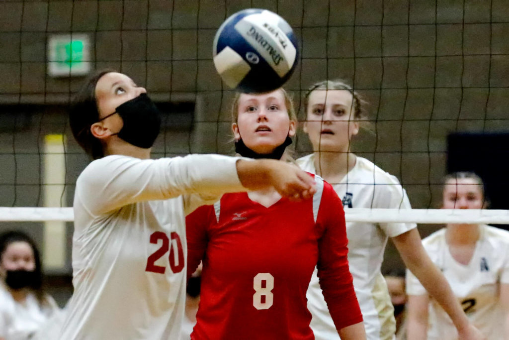 Snohomish’s Lauren Ellis volleys with teammate Reagan Bullock looking on Wednesday night at Arlington High School on September 29, 2021. The Eagles won in straight sets. (Kevin Clark / The Herald)
