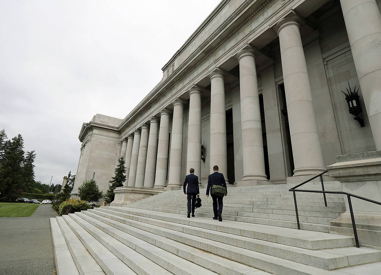 In this 2018 photo, attorneys walk up the steps of the Washington Supreme Court building, the Temple of Justice, in Olympia. (AP Photo/Ted S. Warren, File)
