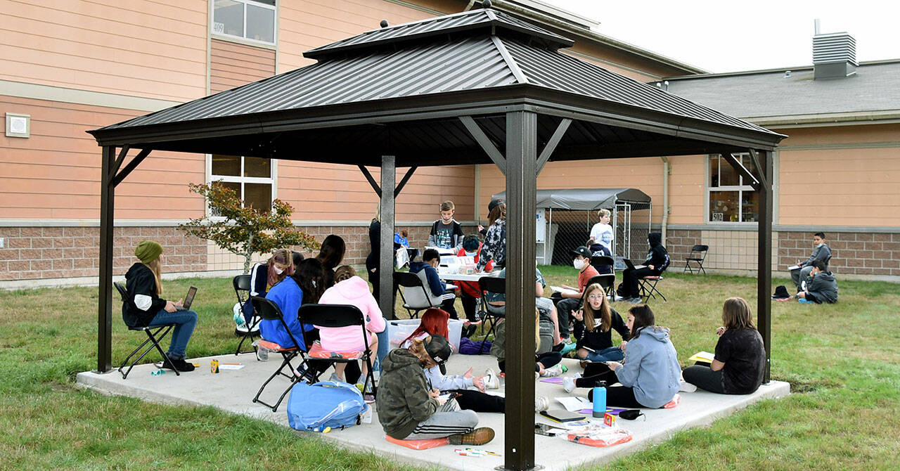 Haller Middle School sixth graders work on a class project in the school’s new outdoor classroom. (Arlington Public Schools)