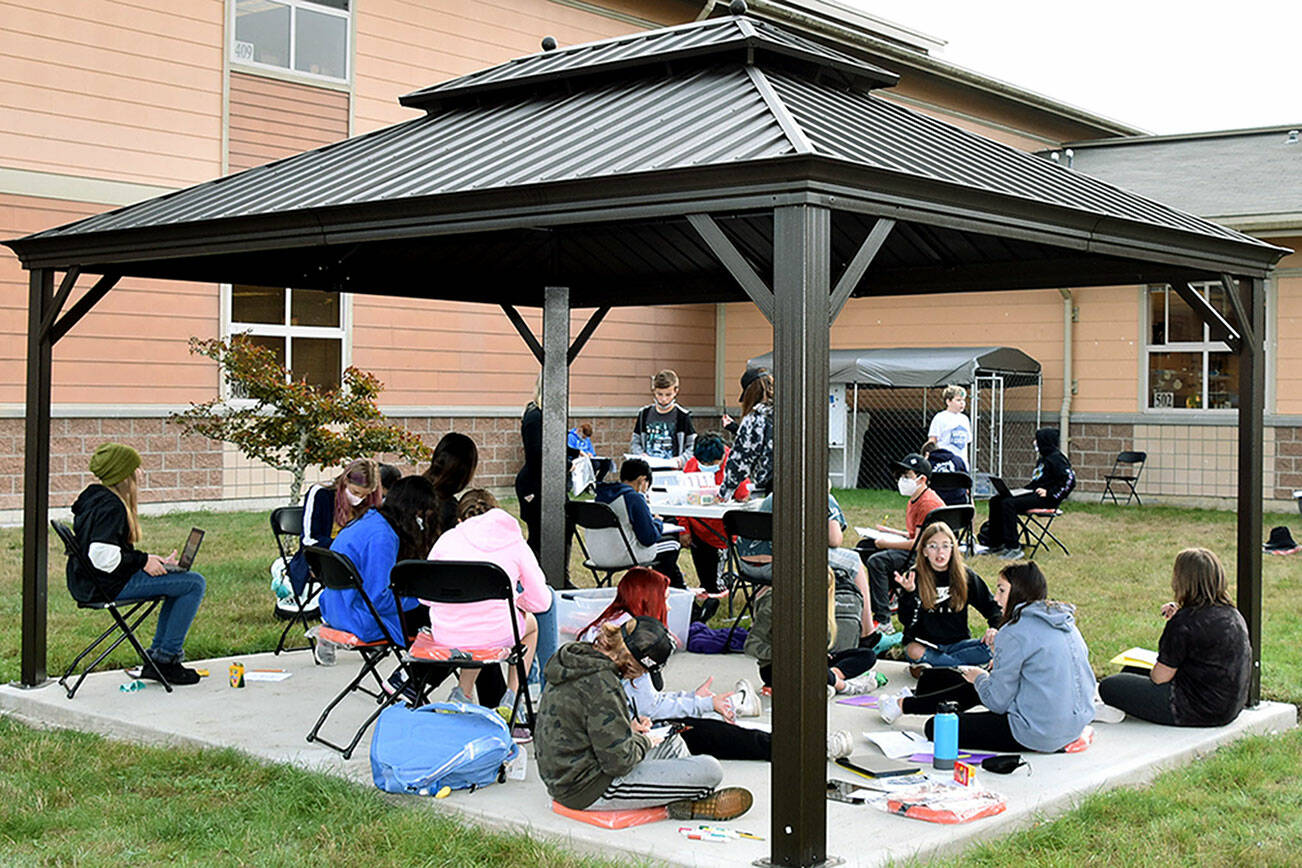Haller Middle School sixth graders work on a class project in the school’s new outdoor classroom. (Arlington Public Schools)