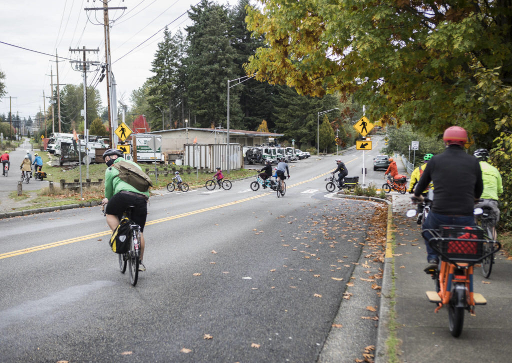 Cyclists cross 216th Street during a tour of a southern segment of the Interurban Trail near Edmonds and Mountlake Terrace. (Olivia Vanni / The Herald) 
