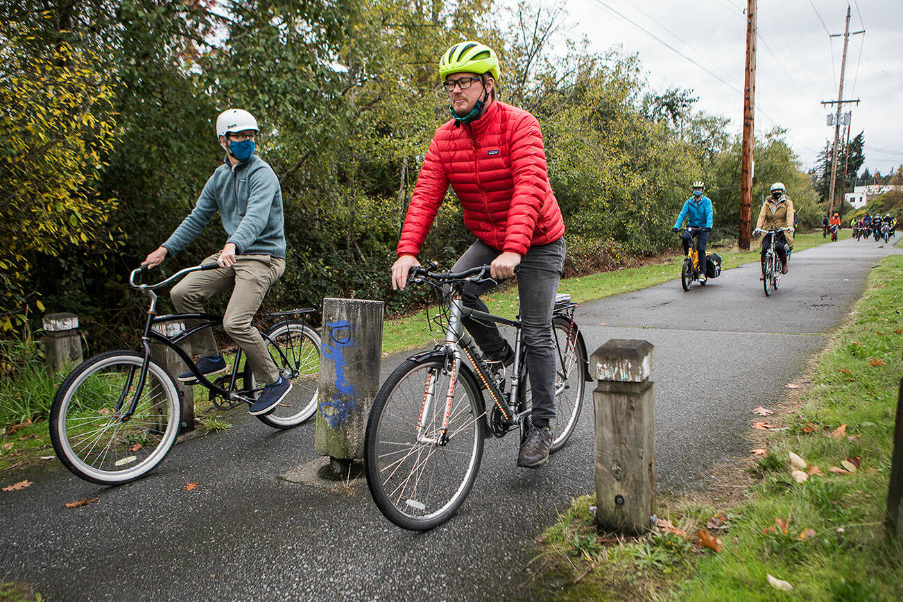 Bikers ride along a segment of the Interurban Trail during a  Leafline Trail Coalition and Snohomish County Transportation Coalition hosted "policy" ride on Saturday, Oct. 16, 2021 in Mountlake Terrace, Wa. (Olivia Vanni / The Herald)