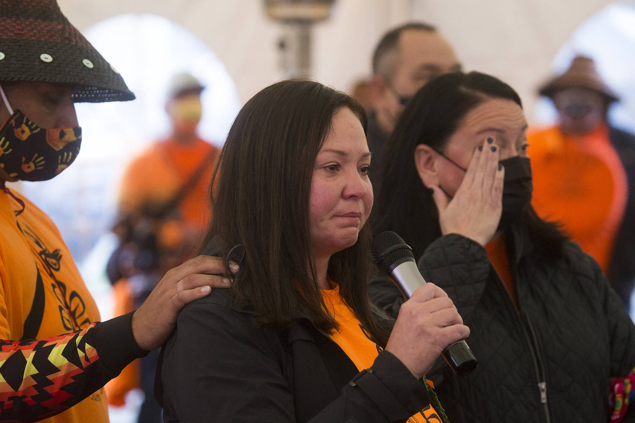 Rochelle Lubbers (center) tears up as she talks about putting her native identity aside while attending school as she and the Tulalip Tribes community gathered at the last remaining building from the Tulalip Indian boarding school for a Day of Remembrance on Thursday in Tulalip Reservation. (Andy Bronson / The Herald)