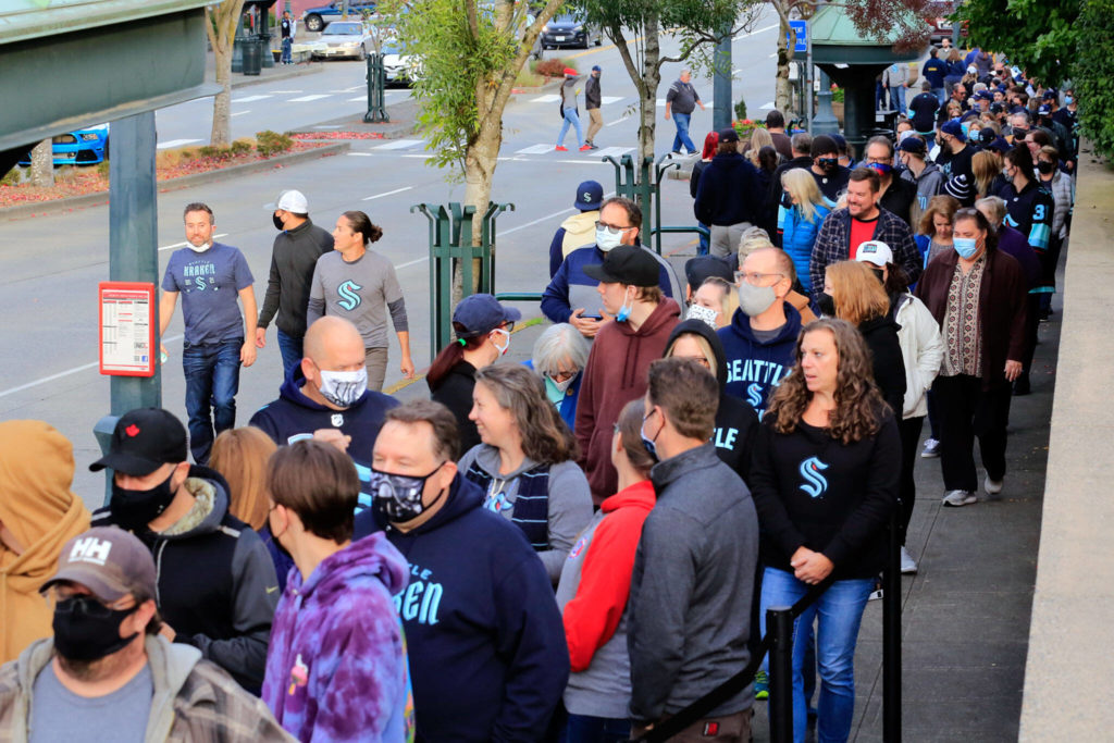 Fans wait in line to enter Everett’s Angel of the Winds Arena for the pre-season game between the Kraken and the Oilers on Friday. (Kevin Clark / The Herald)
