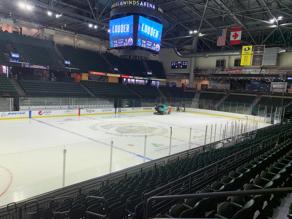 The screen above center ice is still apparently imploring the dozens of employees working to get ready to get “louder.” (Jake Goldstein-Street / The Herald)
