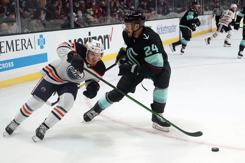 Edmonton Oilers’ James Hamblin (57) skates past Seattle Kraken’s Jamie Oleksiak (2) in the first period of a pre-season NHL hockey game Friday in Everett. (AP Photo/Elaine Thompson)
