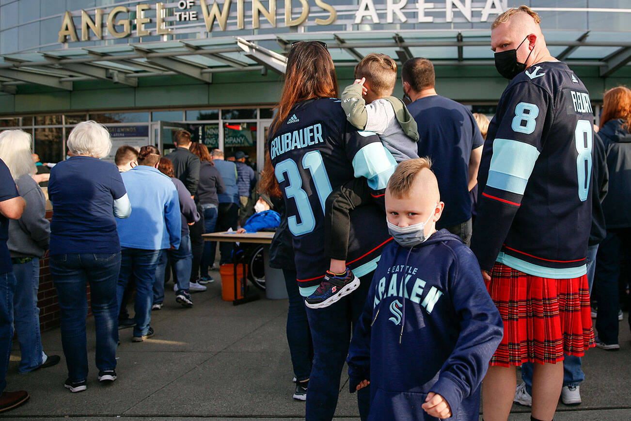 Fans wait in line to enter the Angel of the Winds Arena for the Krakens' pre-season game in Everett on October 1, 2021.   (Kevin Clark / The Herald)
