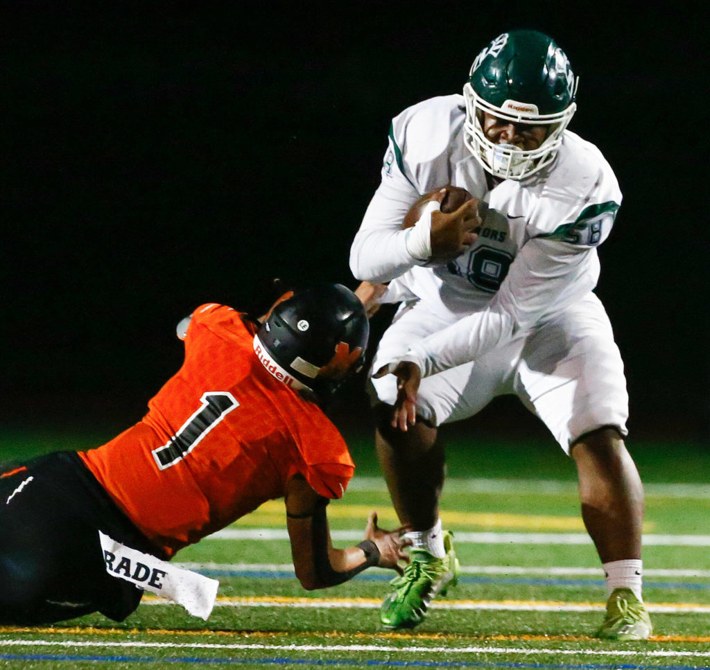 Senior defensive lineman Treasure Jordan returns an interception to the 6-yard line to set up an Edmonds-Woodway touchdown. (Kevin Clark / The Herald)
