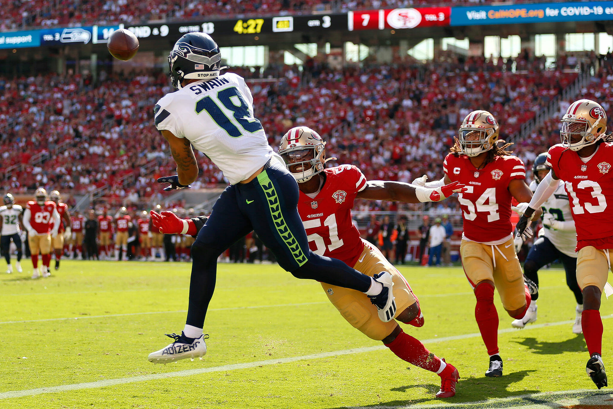 Seattle Seahawks wide receiver Freddie Swain (18) catches a touchdown pass against San Francisco 49ers linebacker Azeez Al-Shaair (51) during the second half of Sunday’s game in Santa Clara, Calif. (AP Photo/Jed Jacobsohn)