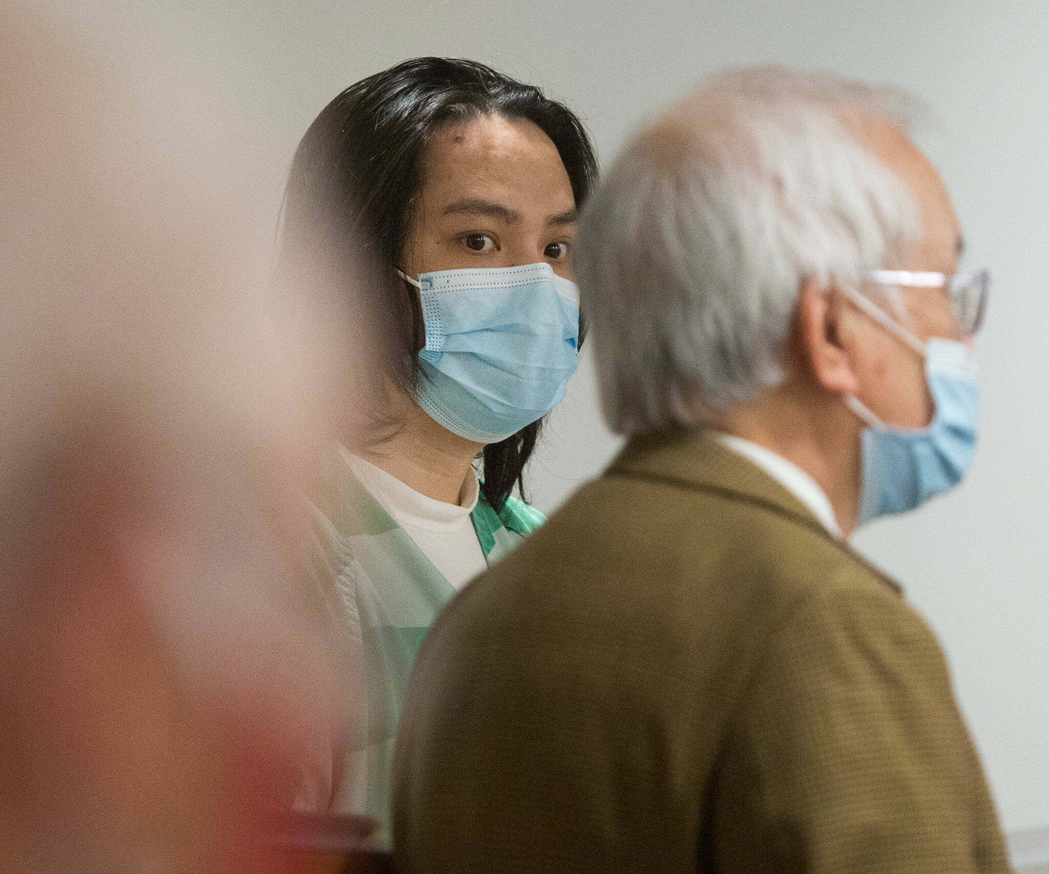Duy Phuong Nguyen (center), 28, of Everett, listens to his interpreter (right) during a plea hearing at the Snohomish County Courthouse on Tuesday in Everett. (Andy Bronson / The Herald)