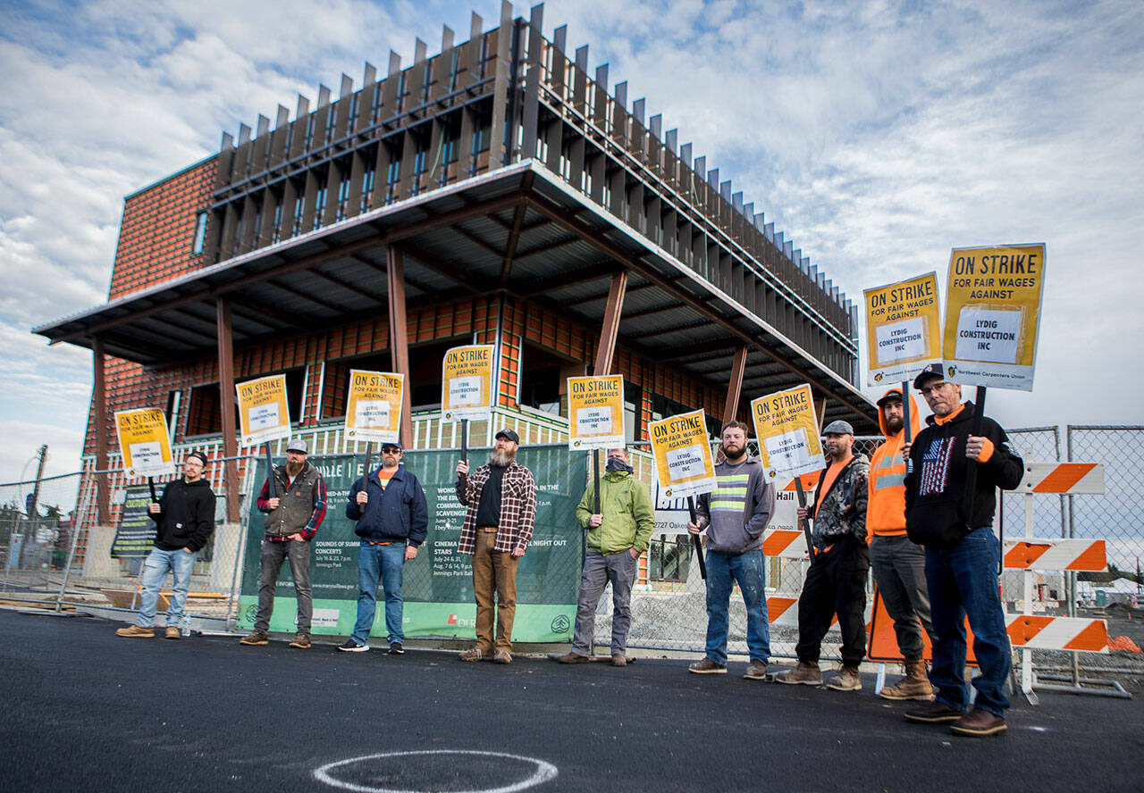 Northwest Union Carpenter members picket in front of the Marysville civic center construction site in Marysville Sept. 22, during a region-wide strike,. (Olivia Vanni / Herald file)