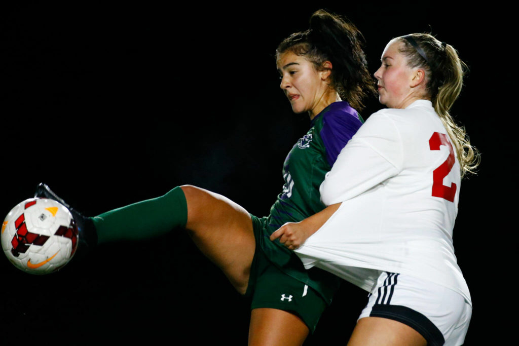 Edmonds-Woodway’s Deanna Montero Vega controls the ball with Snohomish’s Katherine Kennedy holding Thursday night at Edmonds-Woodway High School in Edmonds on October 7, 2021. (Kevin Clark / The Herald)
