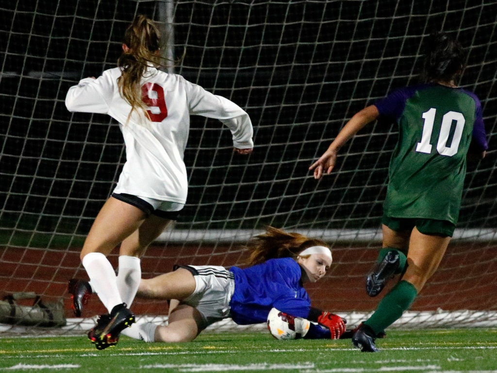 Snohomish’s goal keeper Taylor Graham stops a shot at goal Thursday night at Edmonds-Woodway High School in Edmonds on October 7, 2021. (Kevin Clark / The Herald)
