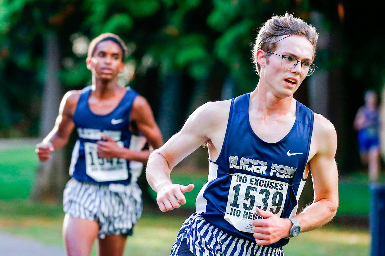 Glacier Peak's Levi Nichols, left, and Nicholas LeBar compete in a meet Wednesday afternoon at Hamlin Park in Seattle on October 6, 2021. (Kevin Clark / The Herald)